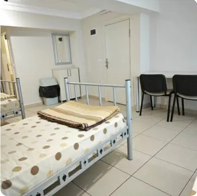 a bed in a room with chairs and a table at Hostelist in Istanbul
