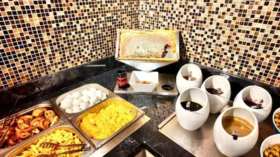 a buffet with eggs and other food on a counter at Aven Hotel in Istanbul