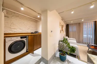 a living room with a washing machine in a room at Liberty Residence in Istanbul