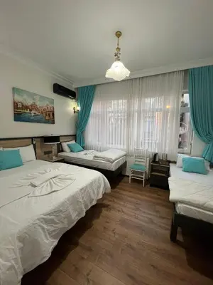 a hotel room with two beds and a window at Sultanahmet Sefa Hotel in Istanbul