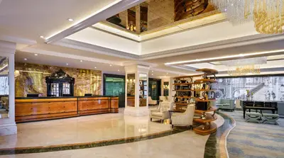 a large lobby with a library with a chandelier at Kaya İstanbul Fair & Convention in Istanbul