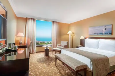 a hotel room with a bed and a large window at Kaya İstanbul Fair & Convention in Istanbul