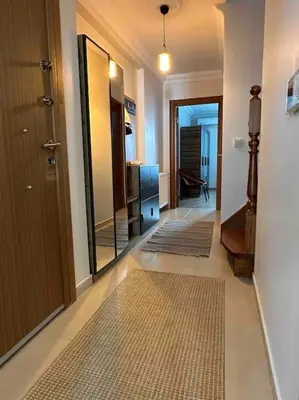 a hallway with a door and a room with rugs at Dublex roof top with AC, perfect location in Istanbul