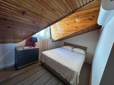 a bedroom with a bed and a wooden ceiling at Dublex roof top with AC, perfect location in Istanbul