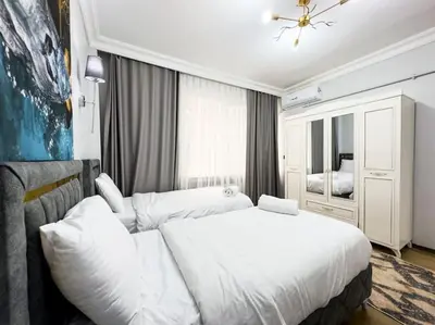 a bedroom with a white bed and a couch at شقه الأحلام بمنطقة شيشلى 341 in Istanbul