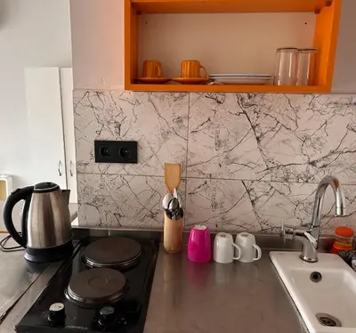 a kitchen counter with a stove and a sink at i1 House Hotel in Istanbul