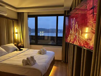 a hotel room with a bed and a large window at Lokka Hotel Ortakoy in Istanbul