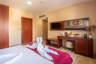 a hotel room with a bed with a person laying on it at Park by Clover Nişantaşı Harbiye Şişli in Istanbul