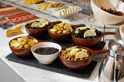 a buffet with bowls of food on a table at Me by Mula in Istanbul