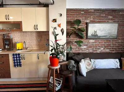a living room with a couch and a brick wall at Cozy Flat to Taxim, Beyoglu, Pera, Galata in Istanbul