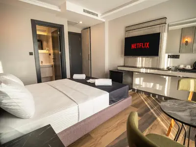 a bedroom with a bed and a tv on the wall at Modernlux Hotel in Istanbul