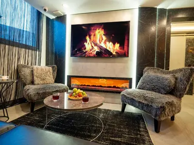 a living room with two chairs and a fireplace at Modernlux Hotel in Istanbul
