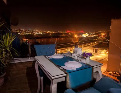 a table on a balcony with a view of a city at Grand Hurriyet Hotel in Istanbul