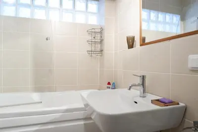 a white bathroom with a sink and a bath tub at Spacious Balcony Suite Sultanahmet - Aslan Apartments in Istanbul