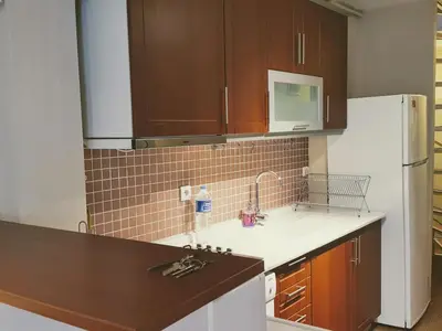 a kitchen with brown cabinets and a white refrigerator at Spacious Balcony Suite Sultanahmet - Aslan Apartments in Istanbul