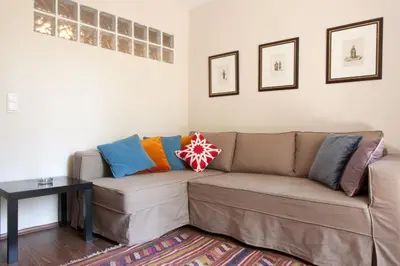 a living room with a brown couch with colorful pillows at Spacious Balcony Suite Sultanahmet - Aslan Apartments in Istanbul
