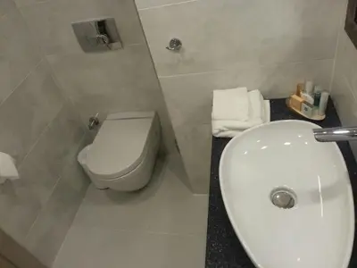 a bathroom with a white toilet and a sink at Perla Galata Hotel in Istanbul