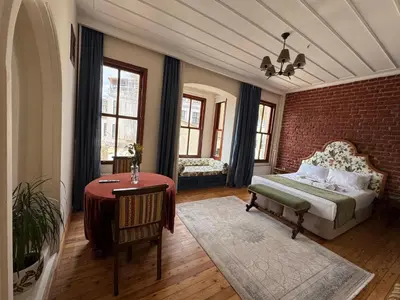 a bedroom with a bed and a brick wall at Levant Pension de Luxe in Istanbul