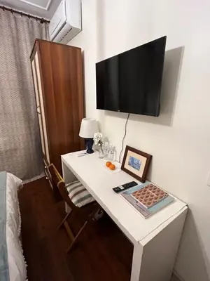 a room with a desk with a television on a wall at Levant Pension de Luxe in Istanbul