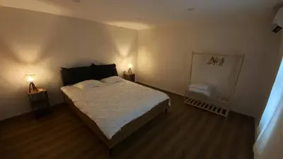 a bedroom with a large bed and two lamps at Özkanlar in Istanbul