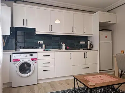 a kitchen with white cabinets and a washing machine at Evinizin Konforunu Yaşayın ! in Istanbul