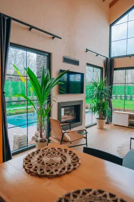a living room with a table and a fireplace at Villa Ulusoy Sapanca in Sapanca