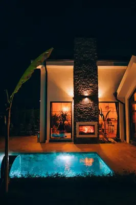 a house with a swimming pool and a fireplace at Villa Ulusoy Sapanca in Sapanca