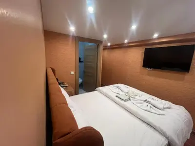 a hotel room with a bed and a flat screen tv at Cemre Homes in Istanbul