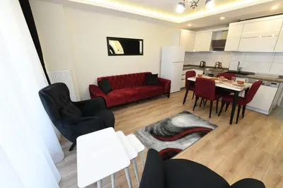 a living room with a red couch and a table at Uzay Apartments in Istanbul