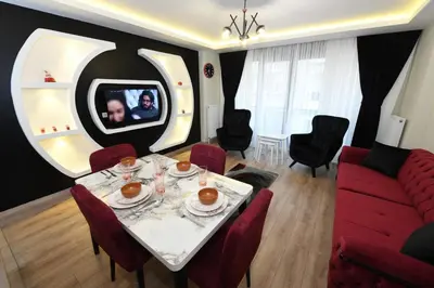 a living room with a table and a red couch at Uzay Apartments in Istanbul