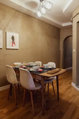 a dining room with a wooden table and chairs at Raya Suites in Istanbul