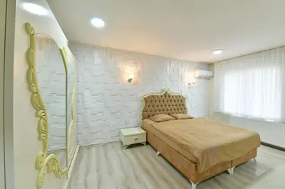 a bedroom with a bed and a white brick wall at Dogancay Suite in Istanbul