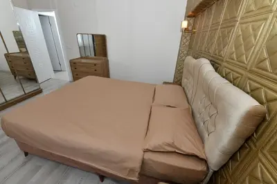 a brown couch in a room with a wall at Dogancay Suite in Istanbul