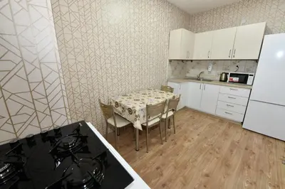 a kitchen with a table with chairs and a refrigerator at Dogancay Suite in Istanbul