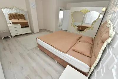 a bedroom with a bed and a mirror at Dogancay Suite in Istanbul