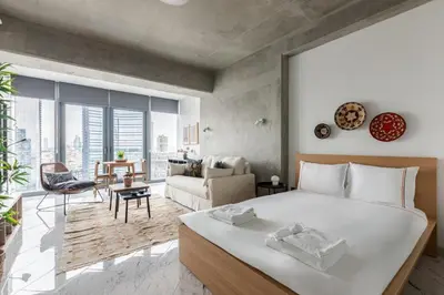 a bedroom with a large bed and a living room at Cozy Bright Studio! ParkingGymPool Access! #374 in Istanbul