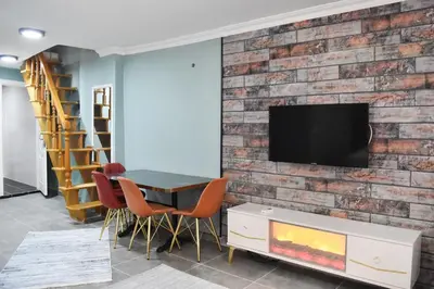 a living room with a brick wall and a table and chairs at Family House in Istanbul