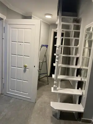 a room with a white ladder next to a door at Family House in Istanbul