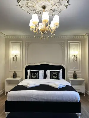 a bedroom with a large bed with a chandelier at Nil Konaklama Sapanca in Sapanca