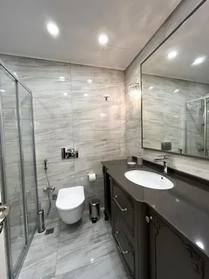 a bathroom with a sink and a toilet and a mirror at Nil Konaklama Sapanca in Sapanca