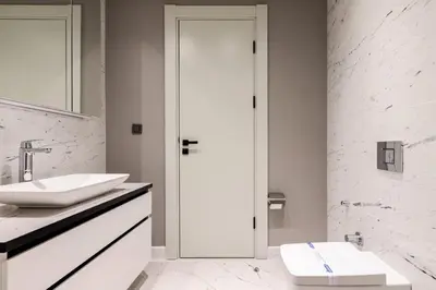 a white bathroom with a sink and a mirror at Beautiful Deluxe 1BD Condo PoolGymParking! #373 in Istanbul