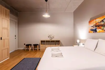 a bedroom with a large white bed and a table at Beautiful Deluxe 1BD Condo PoolGymParking! #373 in Istanbul