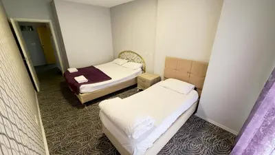 a small room with two beds in it at Güven Suit in Esenyurt
