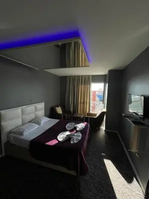 a hotel room with a bed and a tv at Güven Suit in Esenyurt
