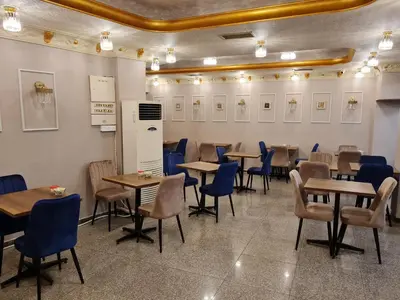 a dining room with tables and blue chairs at Hamit Hotel Istanbul - Special Category in Istanbul