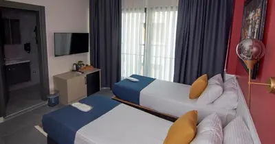 a hotel room with two beds and a television at Zulu Suites in Istanbul