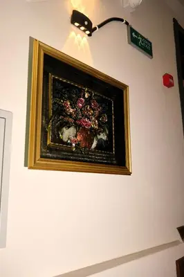 a painting of a vase of flowers on a wall at Zulu Suites in Istanbul