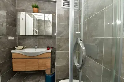 a bathroom with a sink and a shower at Kardes Apartment in Istanbul