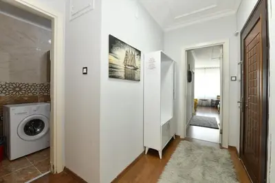 a hallway with a washing machine and a door at Nasiroglu Apartment in Istanbul