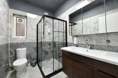 a bathroom with a shower and a toilet and a sink at Sevim Apartment in Istanbul